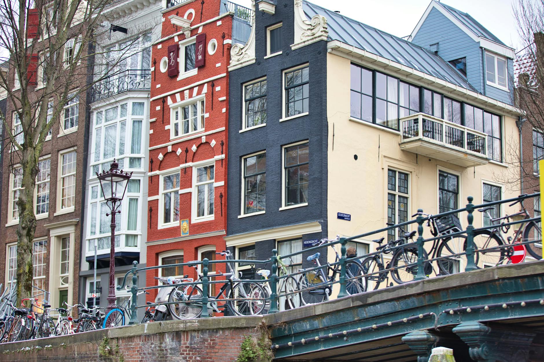 Bicycles lined up along an Amsterdam canal, symbolizing the city's famous cycling culture that visitors can experience through bike rentals