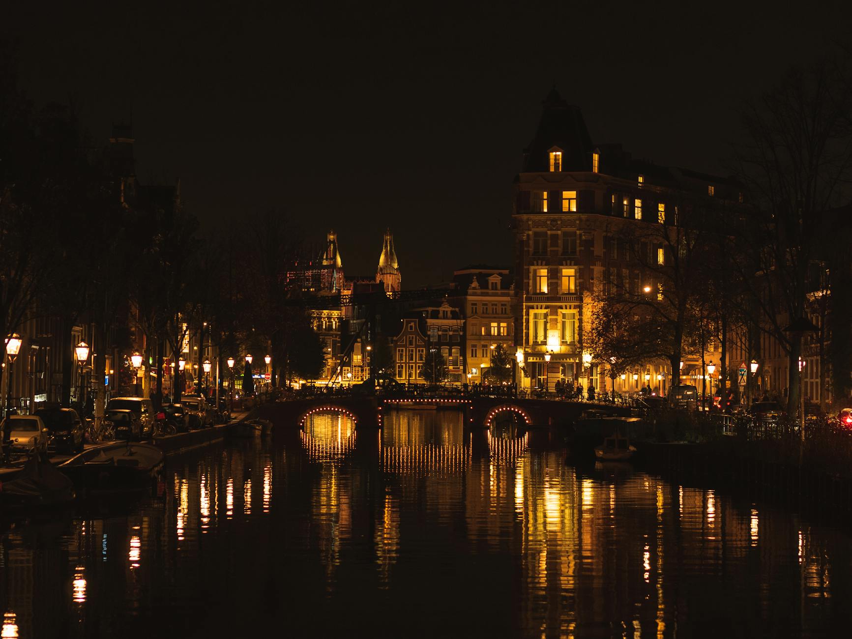 Amsterdam illuminated at night, showcasing the vibrant nightlife scene across Leidseplein, Rembrandtplein, and the historic canal district