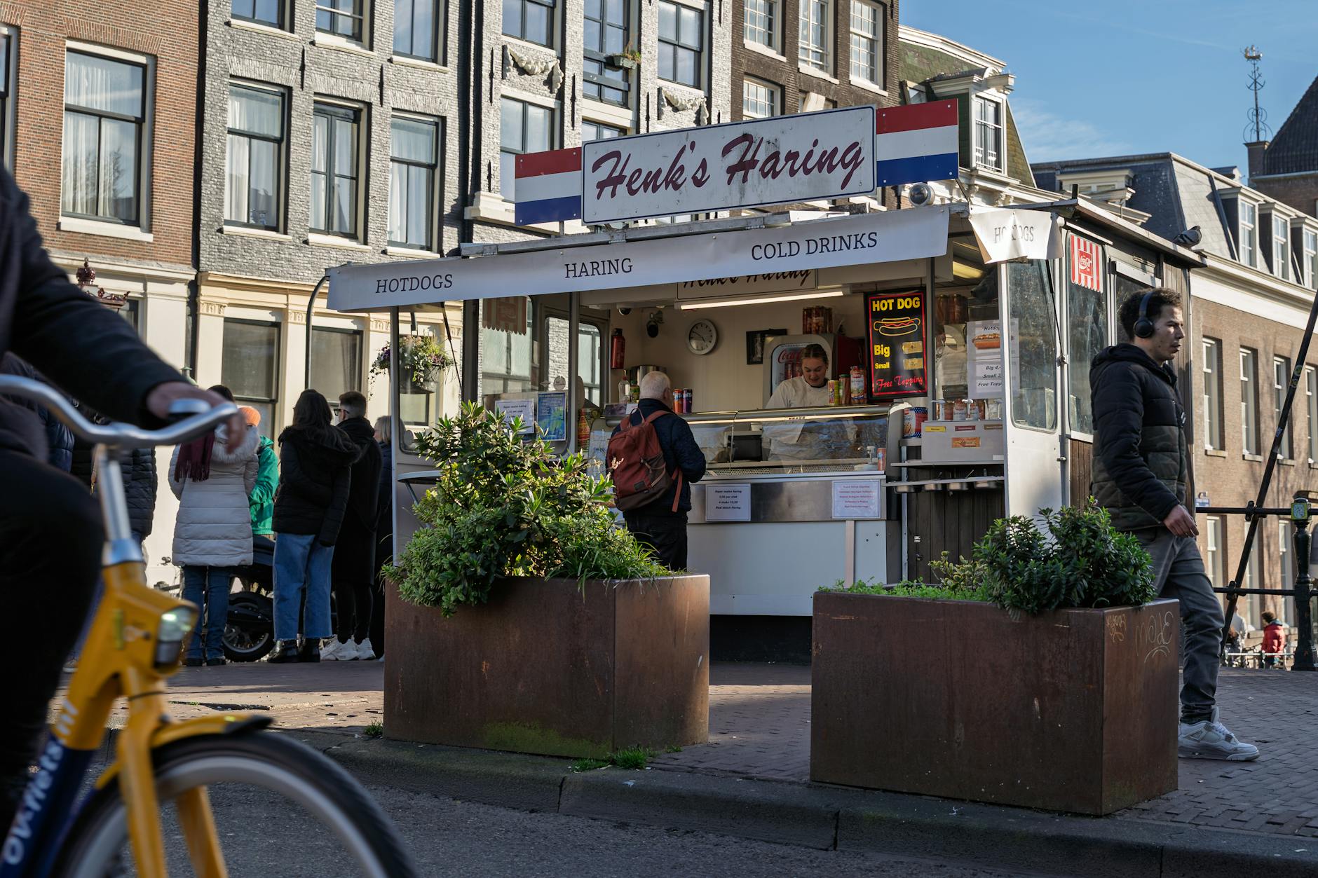 Fresh Dutch street food at one of Amsterdam's vibrant outdoor markets, where visitors can try stroopwafels, herring, and local cheese