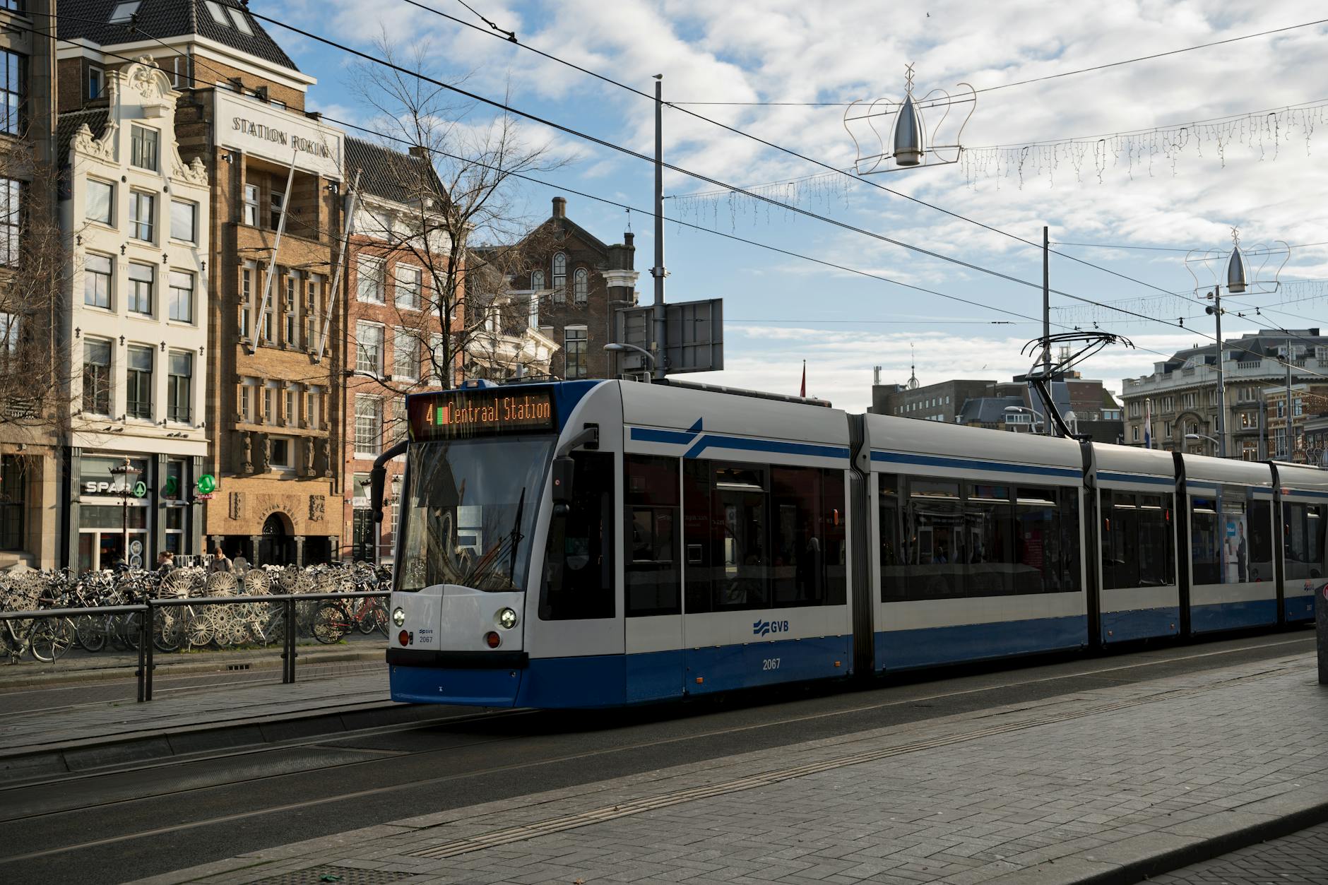 An Amsterdam GVB tram gliding through the city streets, the backbone of public transport