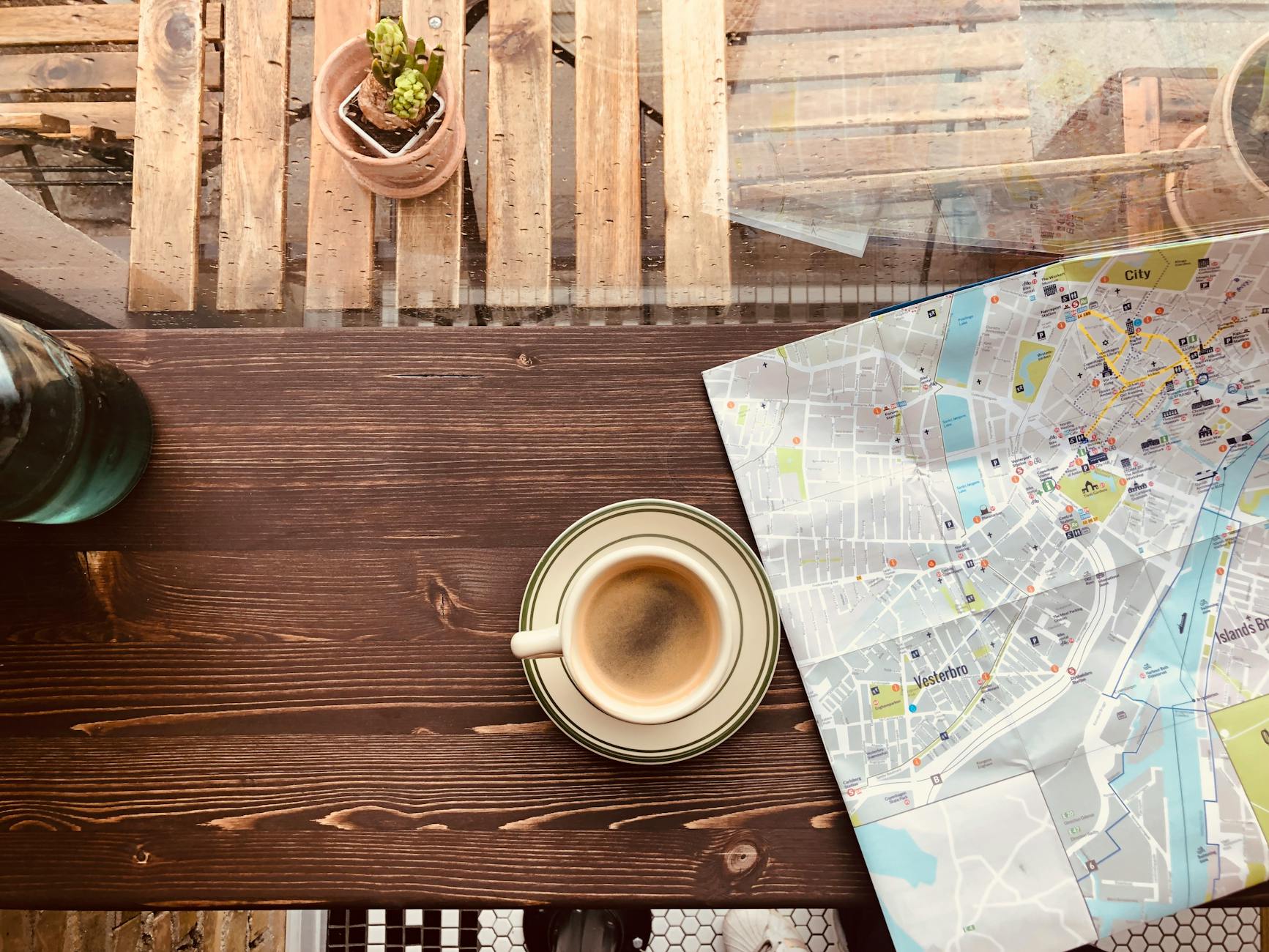 Travel planning with map and coffee for an Amsterdam trip budget