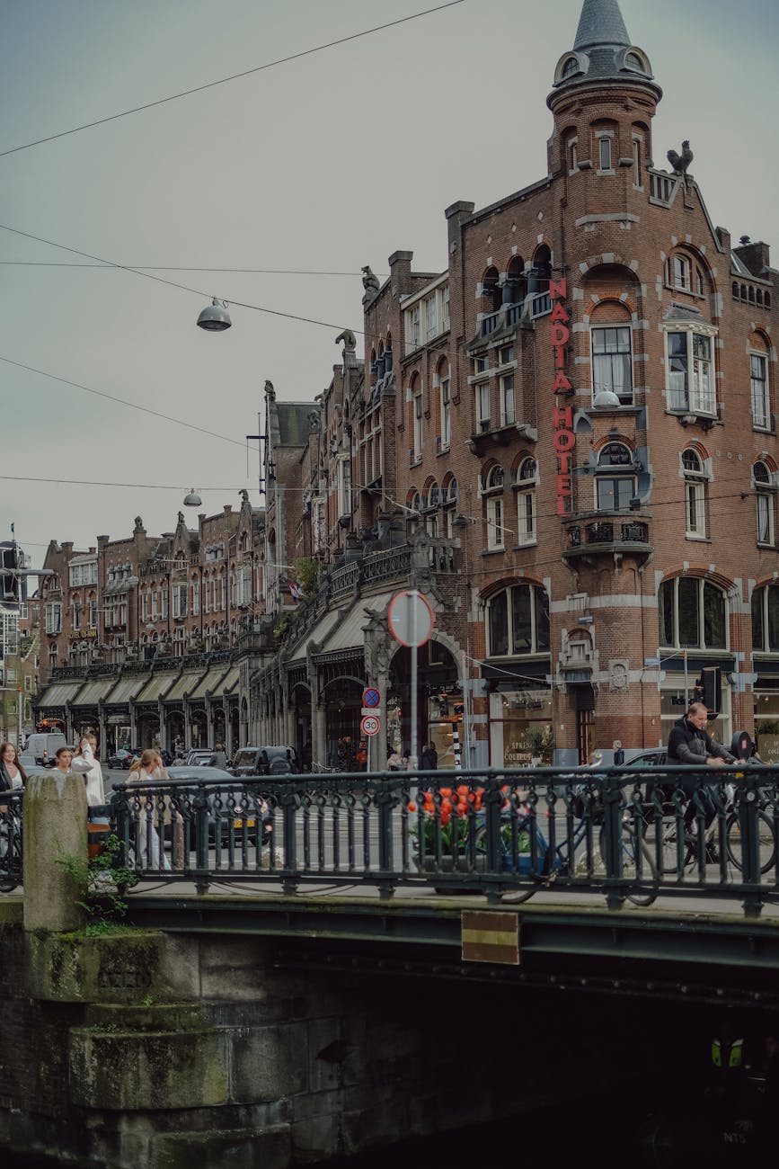 Walking across one of Amsterdam's picturesque canal bridges, the best way to discover hidden neighborhoods