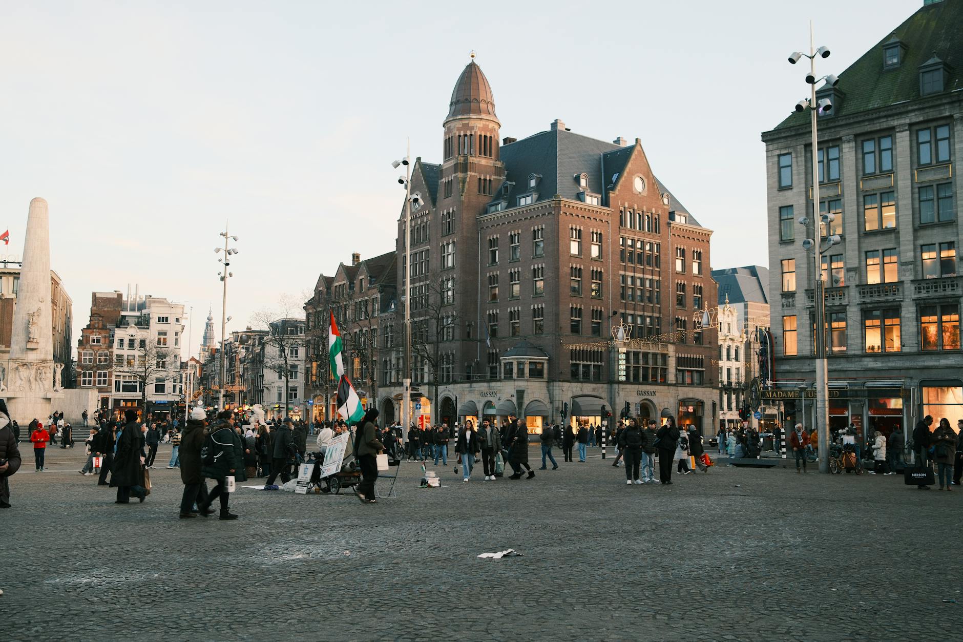 Dam Square in Amsterdam with crowds, the Royal Palace and the historic buildings around it