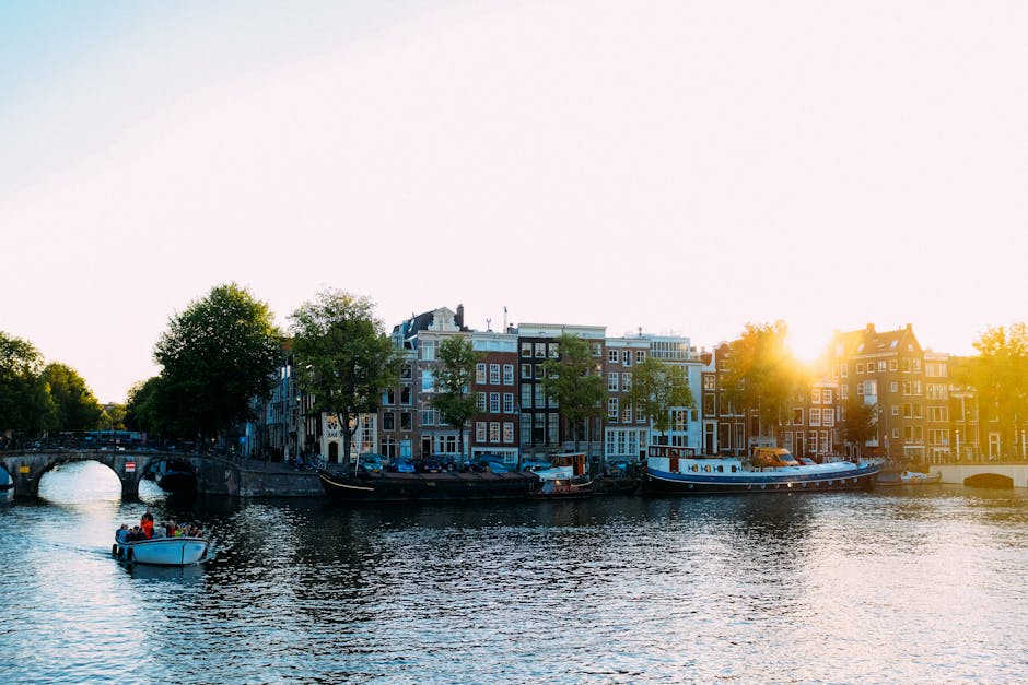 Amsterdam canal in summer with sunshine and boats
