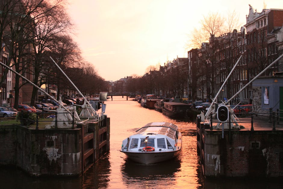 Couple on Amsterdam canal bridge sunset romantic