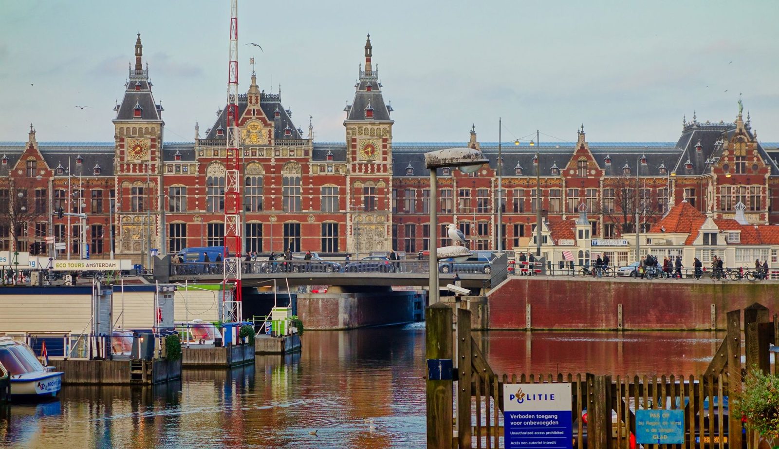 Canal beside Amsterdam Centraal Station, a convenient base for first-time visitors staying near Central Station