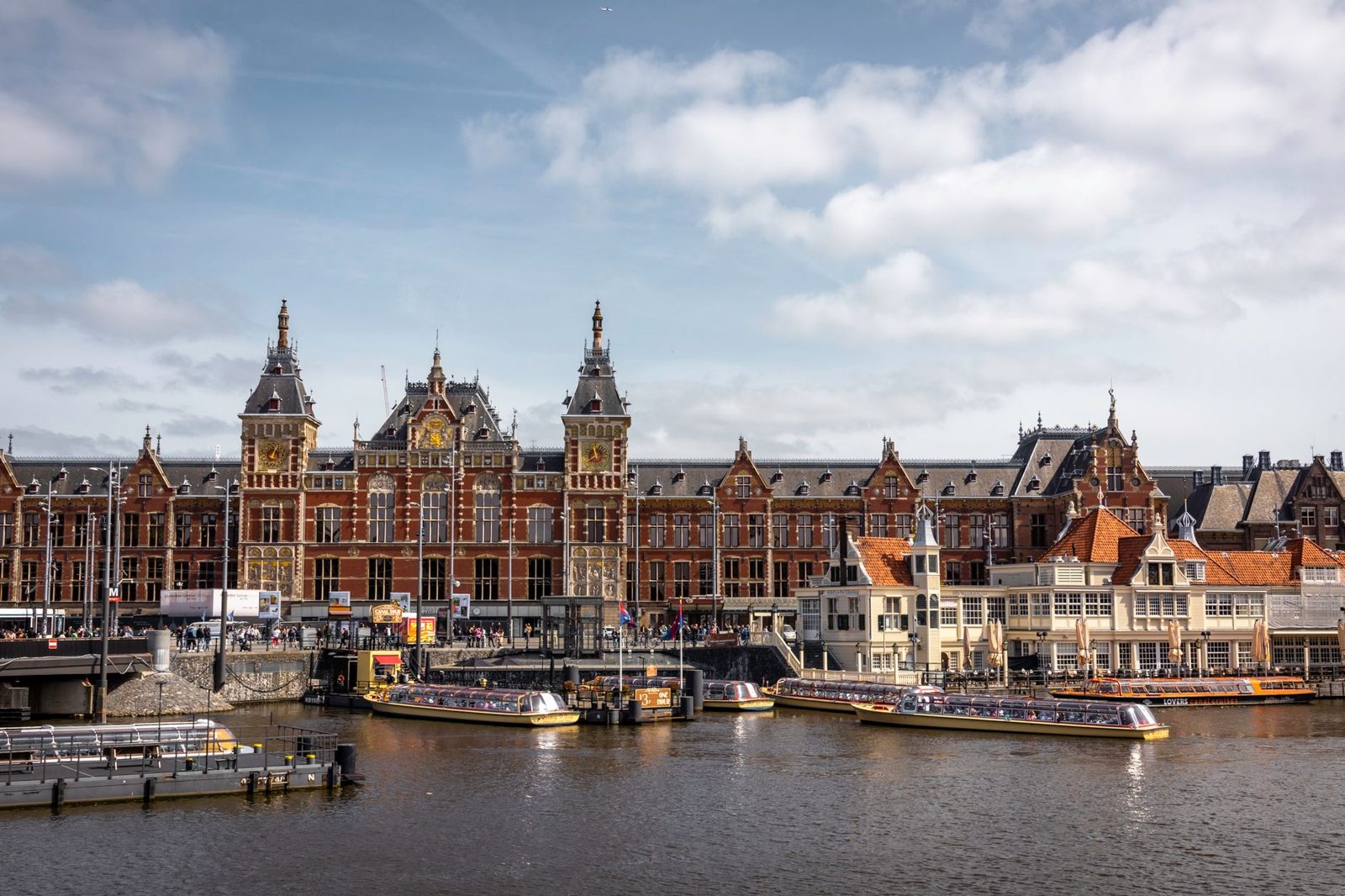 Amsterdam Centraal waterfront with free IJ ferries to Noord, a budget option near Central Station