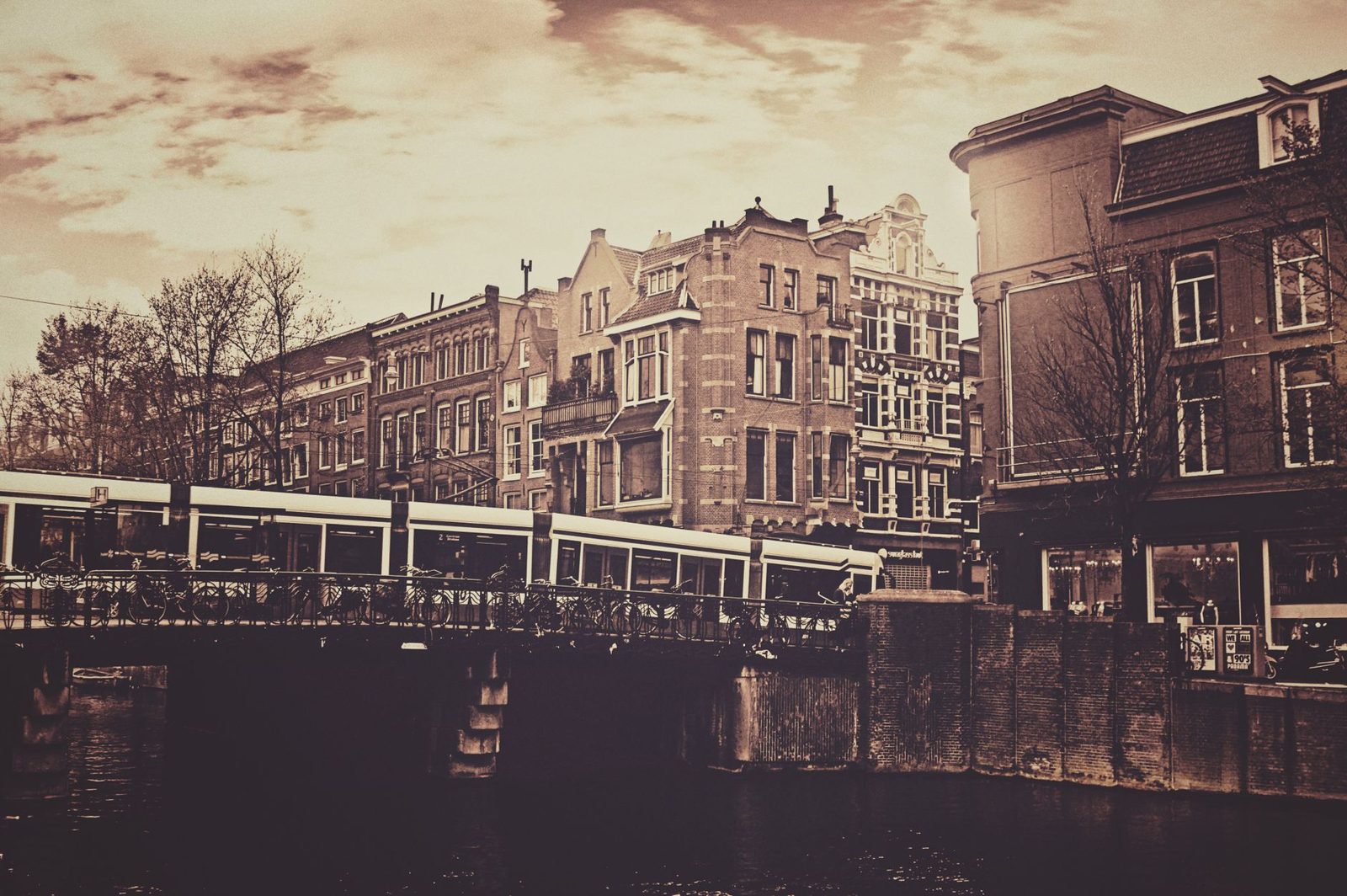 Amsterdam GVB tram crossing a canal bridge in the city centre