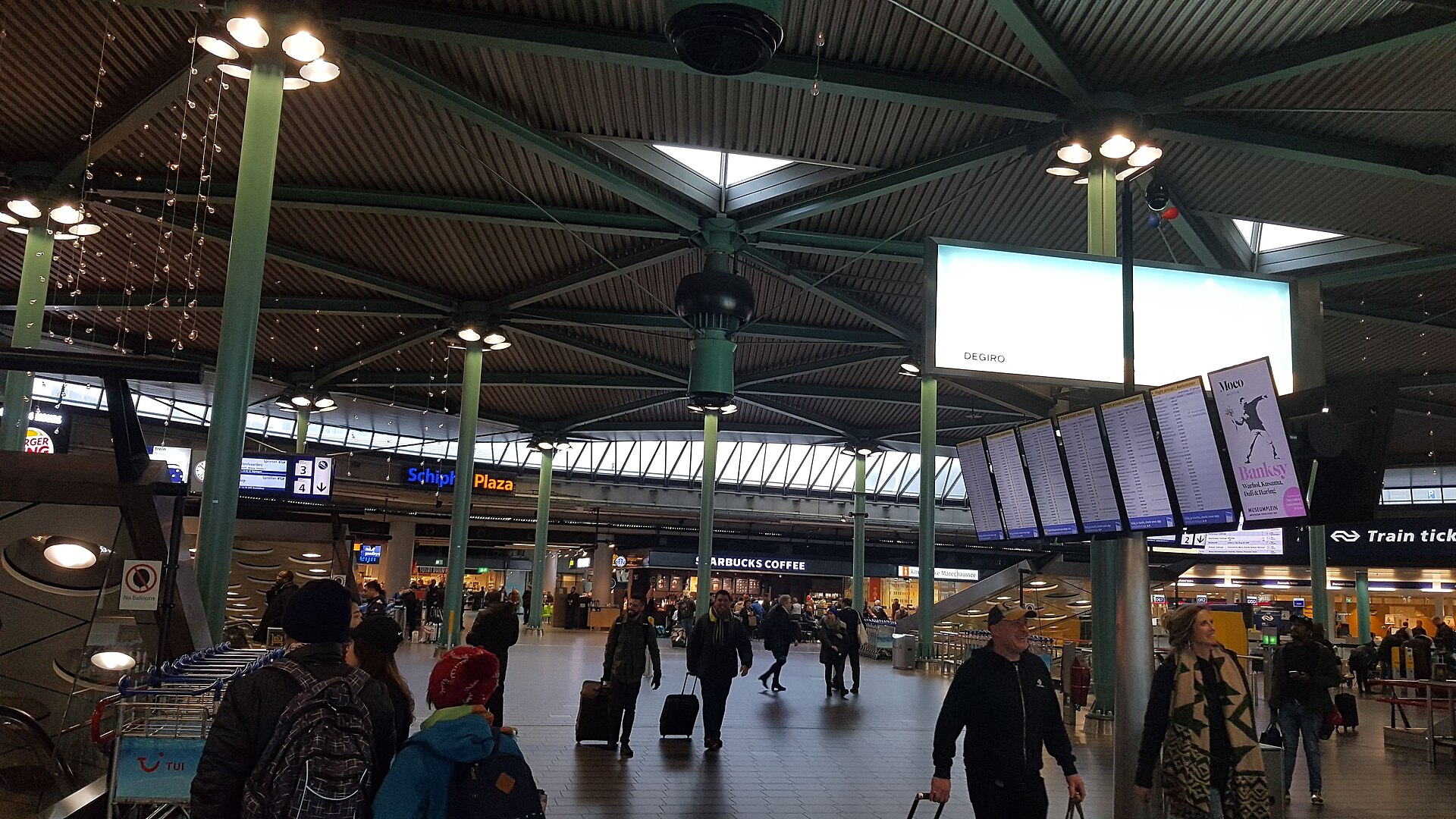 Schiphol Plaza, the landside concourse above the railway station, with train ticket desks and departure boards