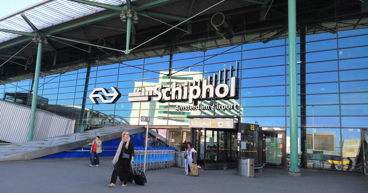 The main entrance to Amsterdam Airport Schiphol, with the Schiphol Plaza sign above the doors