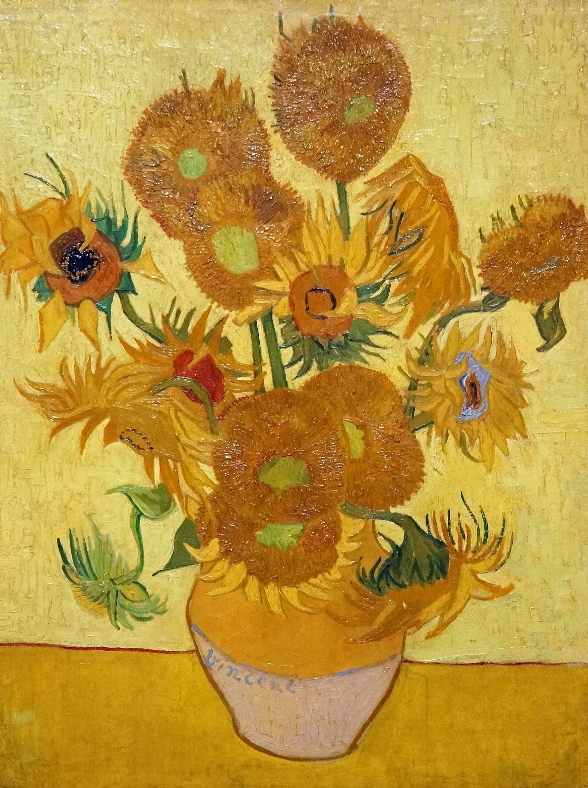 Van Gogh’s Sunflowers at Amsterdam’s Van Gogh Museum shows yellow and ochre blooms arranged in a vase against a yellow background.